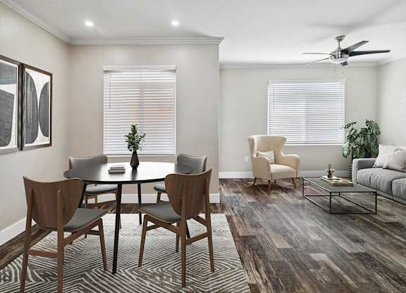 A dining room with a round table and chairs.