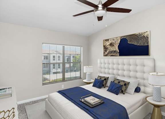 A bedroom with a large bed and a ceiling fan.