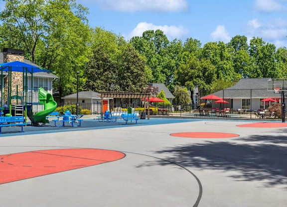 A playground with a red circle in the middle of the ground.