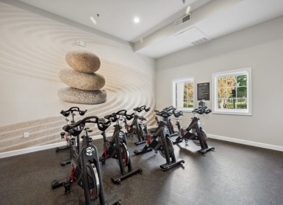 a room filled with lots of bikes and a circular structure in the middle of the room
