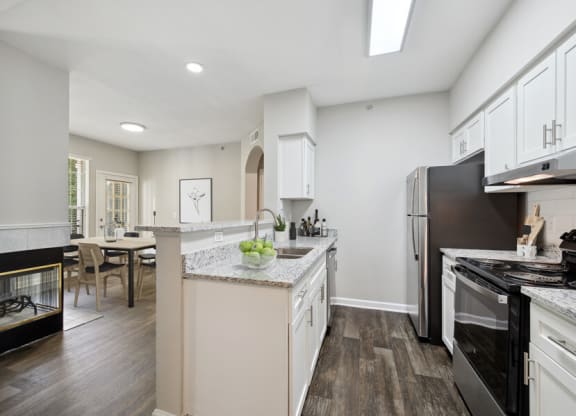 a kitchen with white cabinets and a black stove top oven