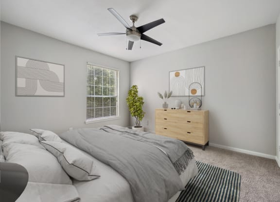 a bedroom with a large bed and a ceiling fan