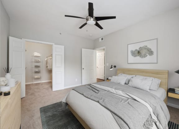 a bedroom with a large bed and a ceiling fan