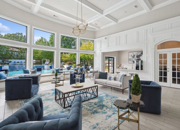 a living room with a coffered ceiling and large windows