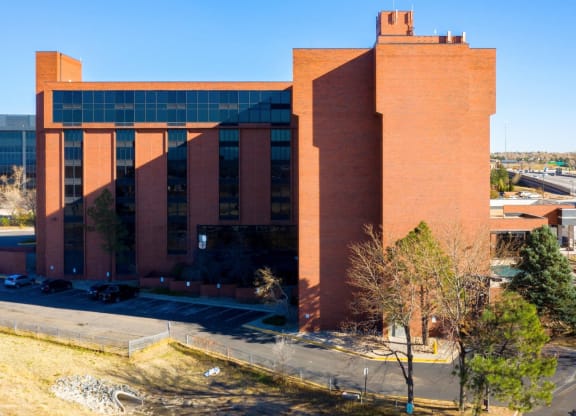 a large brick building with a blue sky in the background