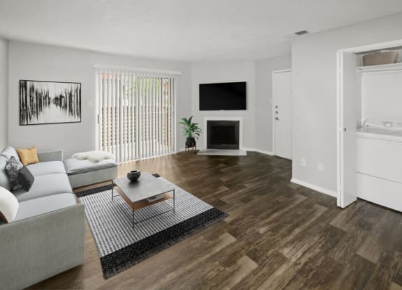 Model apartment living room with a couch and a table