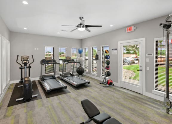 Community gym with treadmills and a ceiling fan