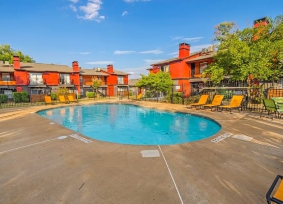 Swimming pool with lounge chairs and cabanas.