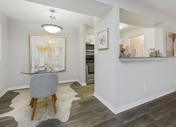 Model dining area with view of kitchen