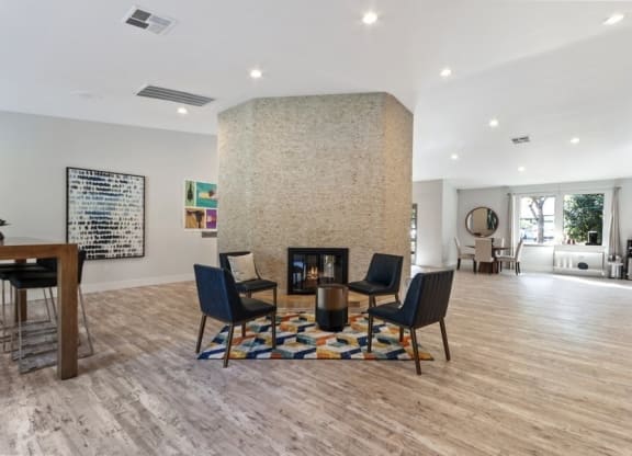 Clubhouse entrance with fireplace and chairs