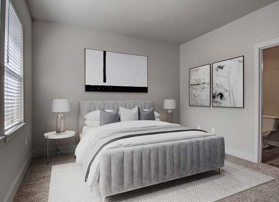 A bedroom with a large bed and two lamps.