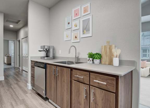 A modern kitchen with wooden cabinets and a white countertop.