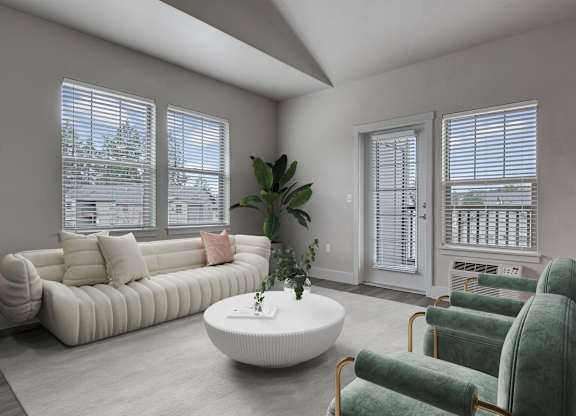 A living room with a white sofa, green armchairs, and a white coffee table.