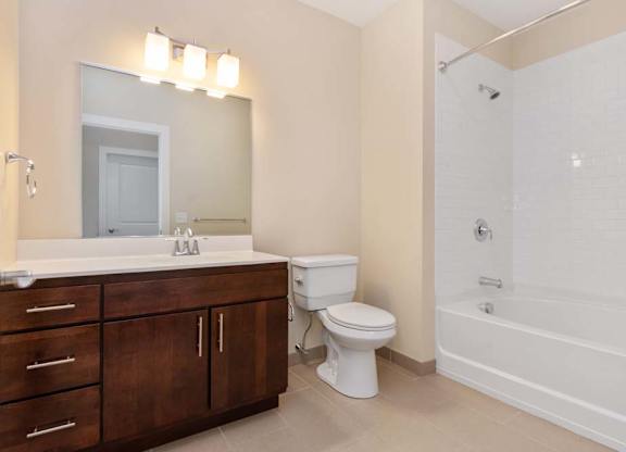 A white toilet sits next to a white sink in a bathroom.