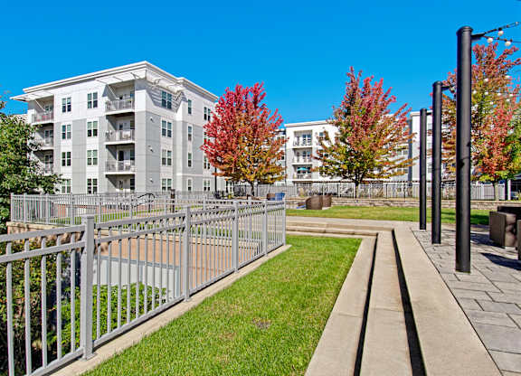 A grey building with a metal fence in front of it.