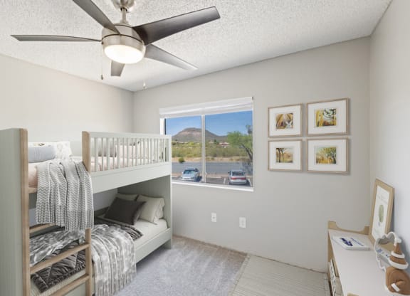 Model apartment bedroom with a bunk bed and a ceiling fan