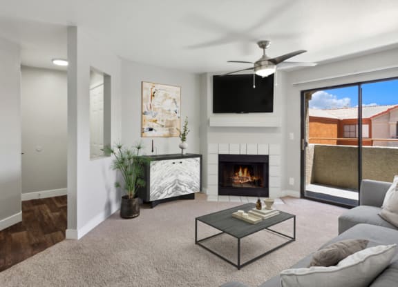 a living room with a fireplace and a flat screen tv