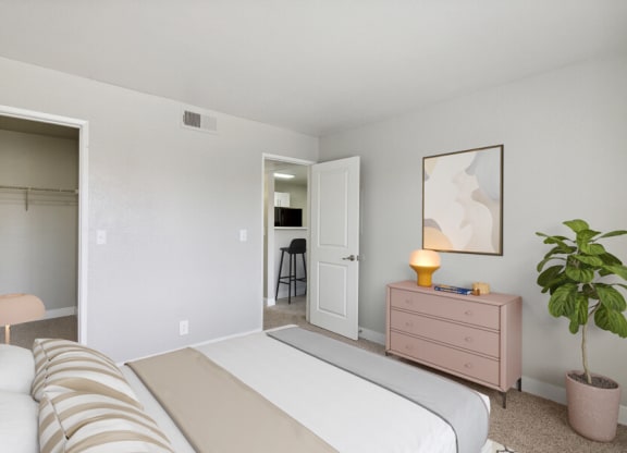a bedroom with a bed and a dresser