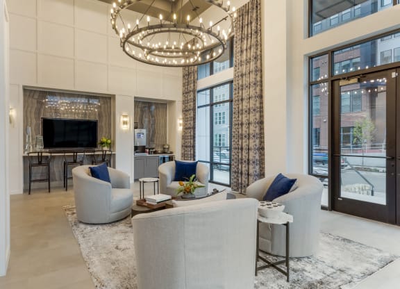 a living room filled with furniture and a large chandelier
