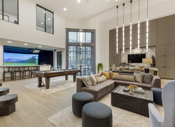 an open concept living room and dining room with a pool table and foosball table