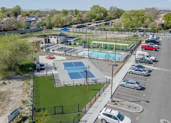 A park with a basketball court, a tennis court, and a swimming pool.