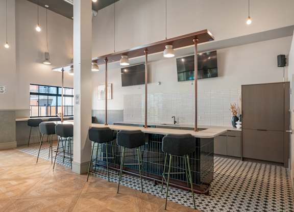 A kitchen with a bar area and a sink.