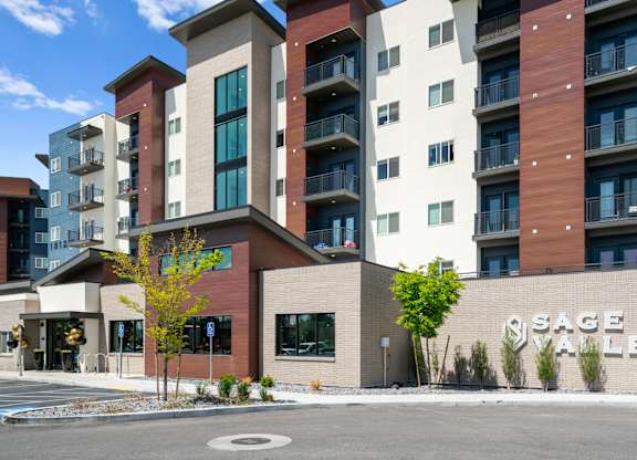 A modern apartment complex named Sage Valley is shown in the image.