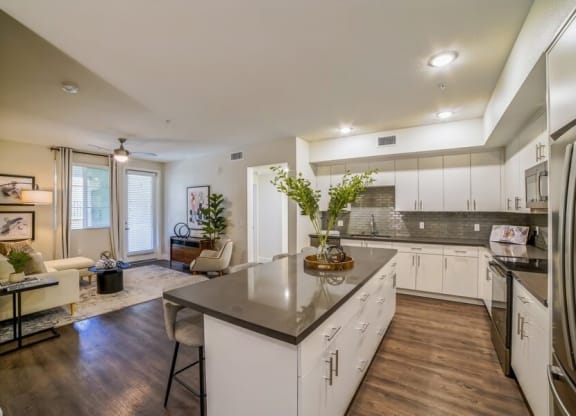 Model kitchen with white cabinetry and island