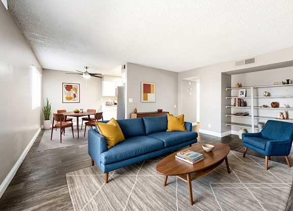 Model Living Room with Wood-Style Flooring at Bridges at Tropicana Apartments located in Las Vegas, Nevada.