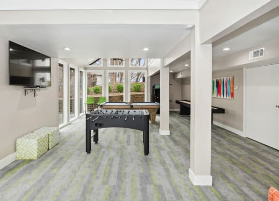a game room with a pool table and a tv
