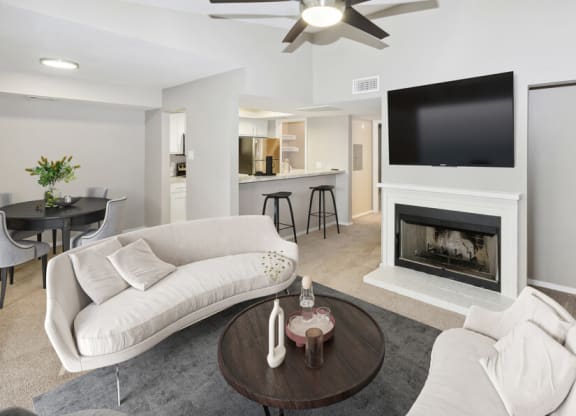 a living room with a white couch and a fireplace