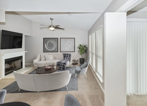a living room with white furniture and a fireplace