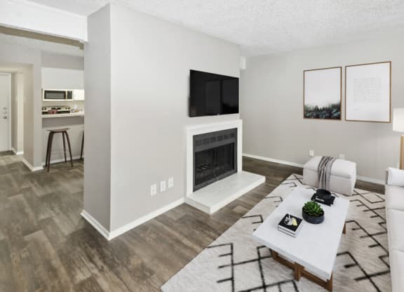 a living room with a fireplace and a table