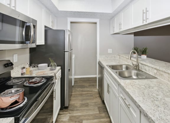 a kitchen with granite counter tops and stainless steel appliances