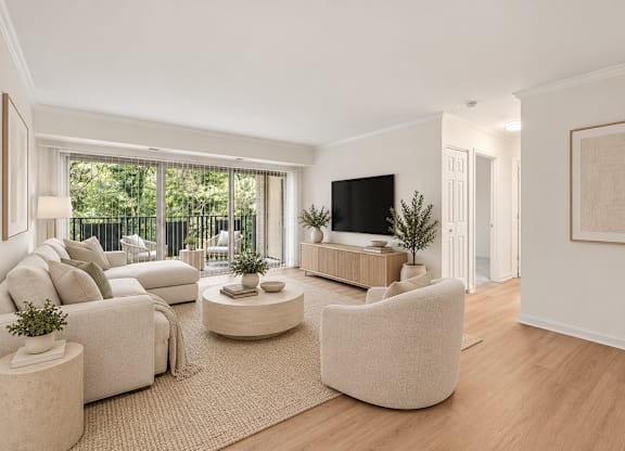 A living room with a white couch, a white chair, a white coffee table, a white rug, a white wall, a white door, a white floor, a white ceiling, a white lamp, a white plant, a white so