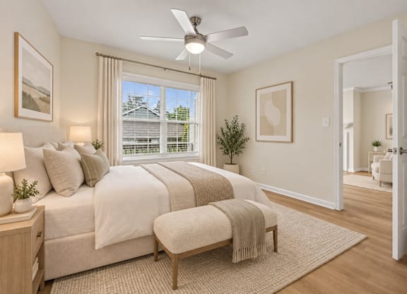 Bright bedroom with ceiling fan and ensuite bathroom at The Courts at Fair Oaks Apartments, Virginia