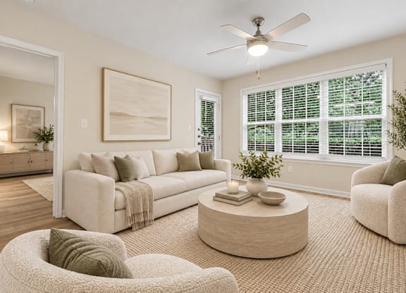 Neutral toned living room with large windows at The Courts at Fair Oaks Apartments, Virginia