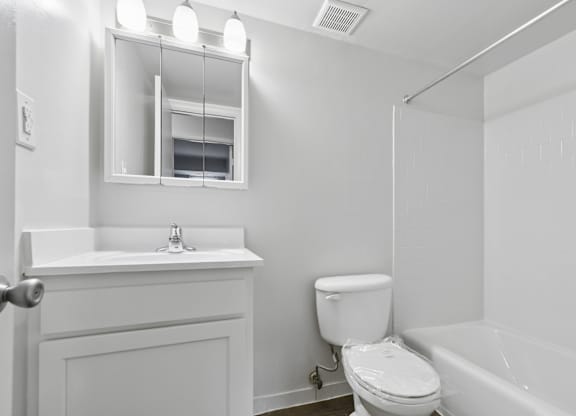 Bright bathroom with white vanity and subway tile at The at Elmwood Terrace Apartments, Frederick, Maryland