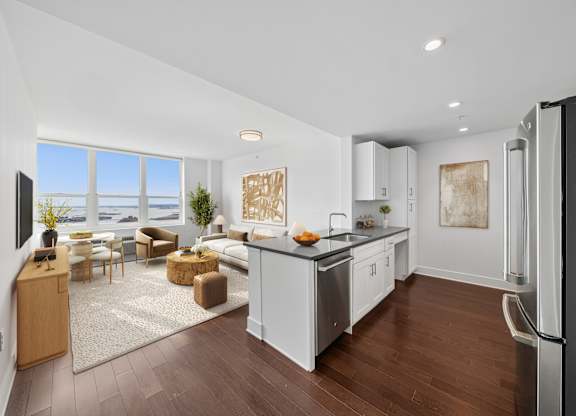 A modern kitchen with white cabinets and a large island.