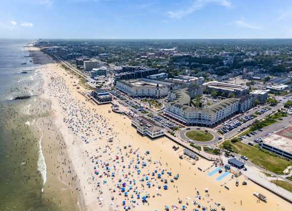 Aerial view of beachfront community with boardwalk at Pier Village Apartments, Long Branch, 7740