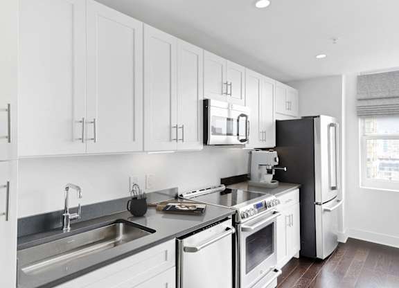 Kitchen with appliances at 65 Bay Street, Jersey City