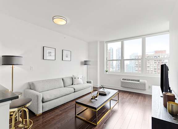 Living room with white couch1 at 65 Bay Street, Jersey City, NJ