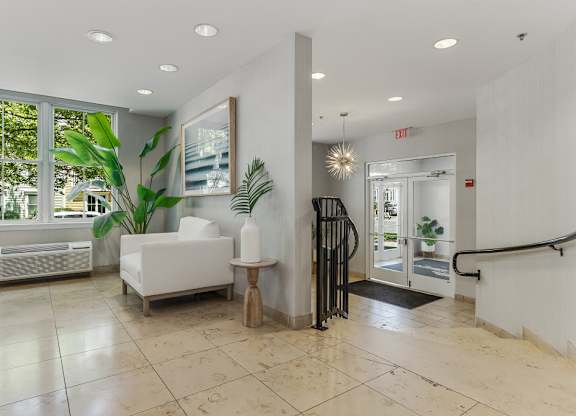 Modern lobby entrance with seating and greenery at Pier Village Apartments, Long Branch, NJ