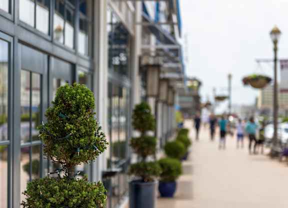 Outdoor shopping promenade with decorative planters at Pier Village Apartments, Long Branch, NJ