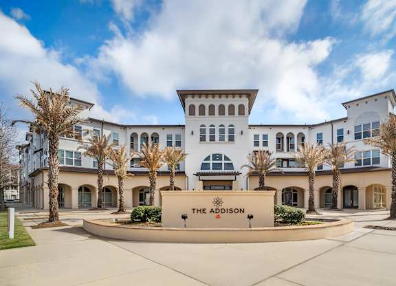 The front of a white building with a sign that says at The Addison,Louisiana