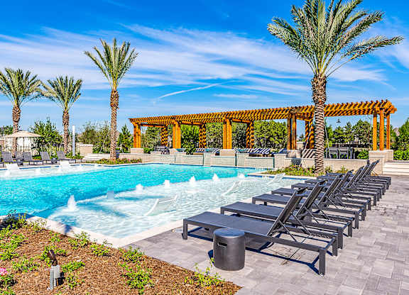 Poolside Sundeck With Relaxing Chairs at Alys Crossing Apartments, Texas