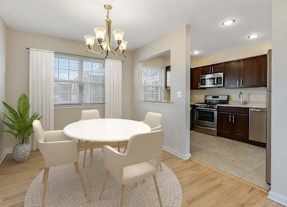 A dining room with a white table and chairs. at Chatham Hill, New Jersey, 07928