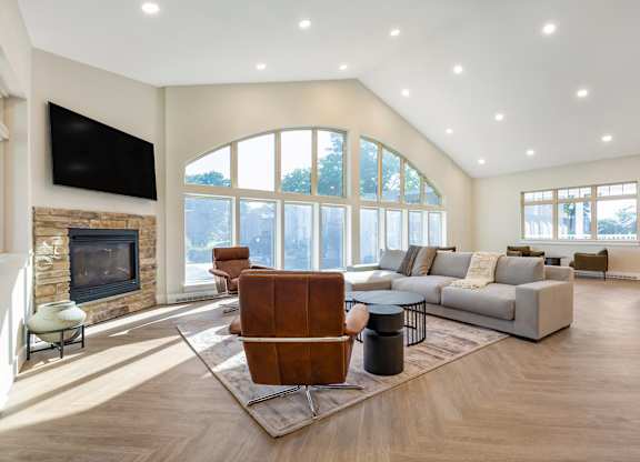 a living room with a couch and a chair and a fireplace at Copper and Quarry Village, Maryland, 21209