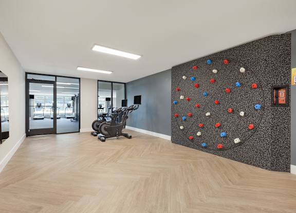 a rock climbing wall in a lobby with a chair at Copper and Quarry Village, Maryland, 21209