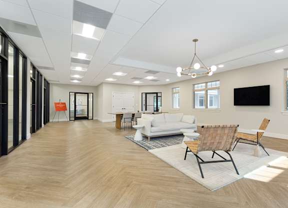 a rendering of a living room with a couch and chairs at Copper and Quarry Village, Pikesville, MD